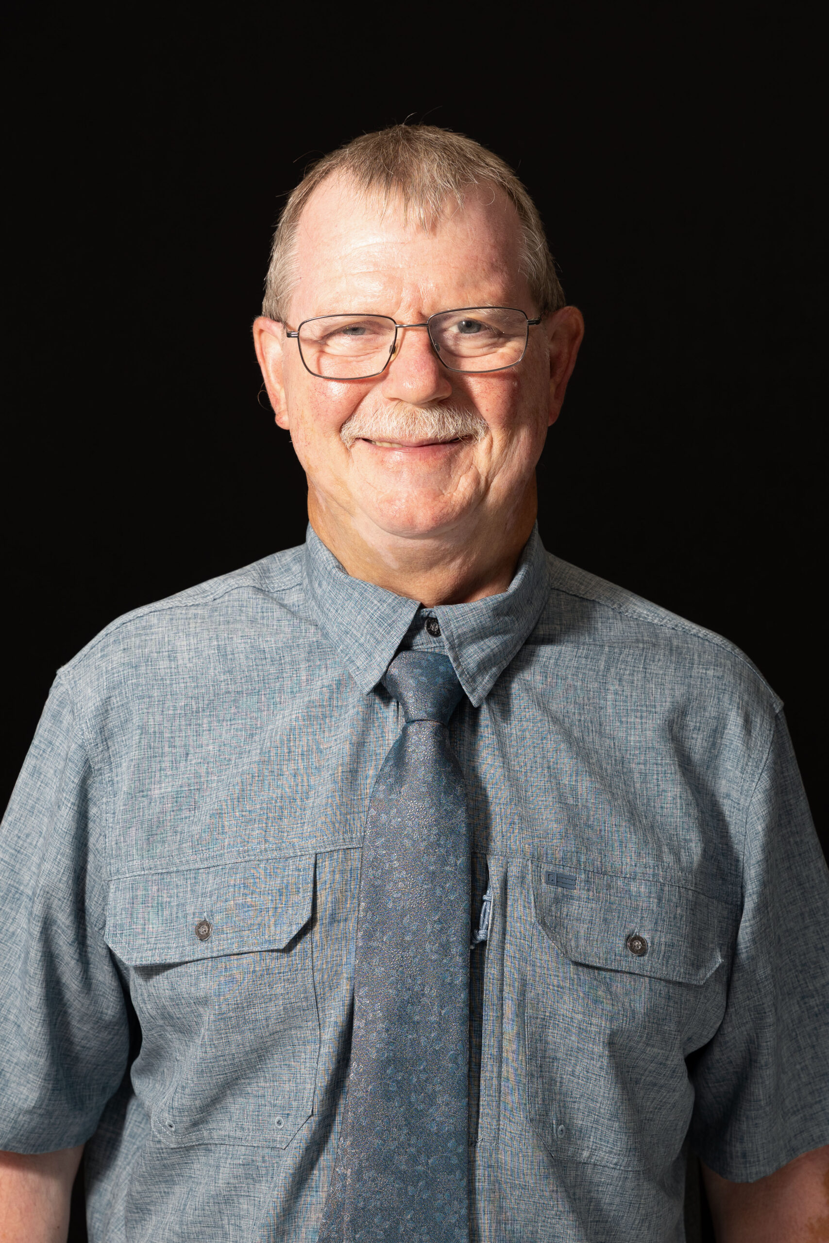 Jim - C a man wearing a hat and glasses